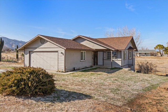 ranch-style house with a garage and a front yard