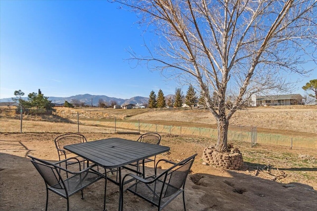 view of patio with a rural view and a mountain view