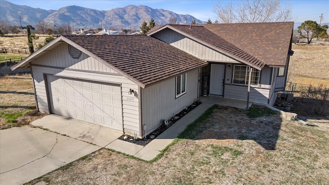 view of side of property featuring a garage and a mountain view