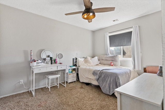 carpeted bedroom with ceiling fan and a textured ceiling