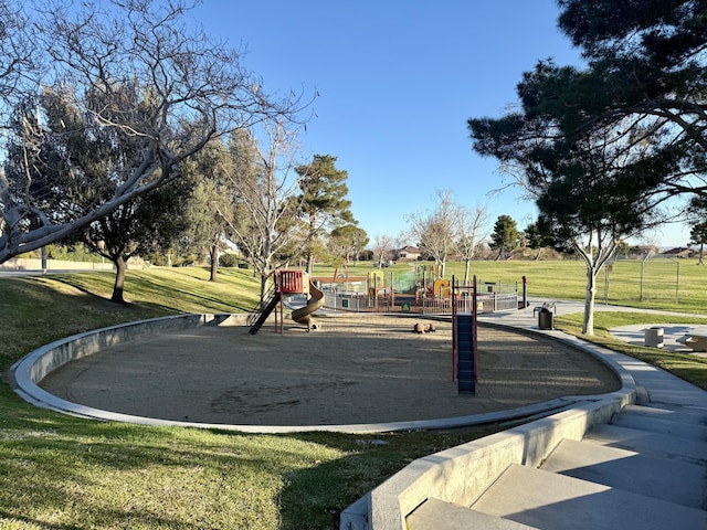 view of home's community with playground community and a lawn