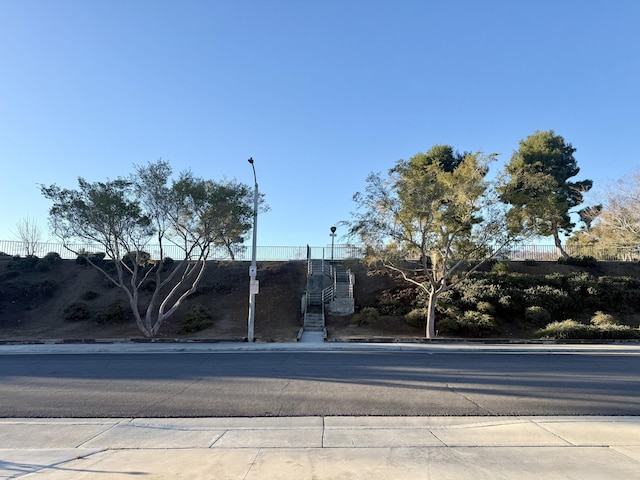 view of street with curbs, street lighting, and sidewalks