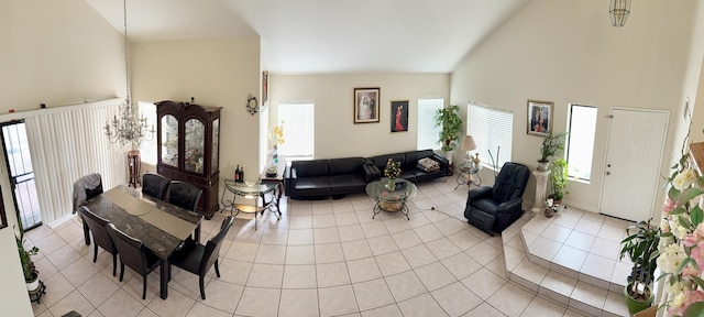 living room with high vaulted ceiling, baseboards, and light tile patterned floors