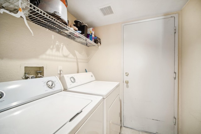 laundry area featuring washer and dryer, laundry area, and visible vents