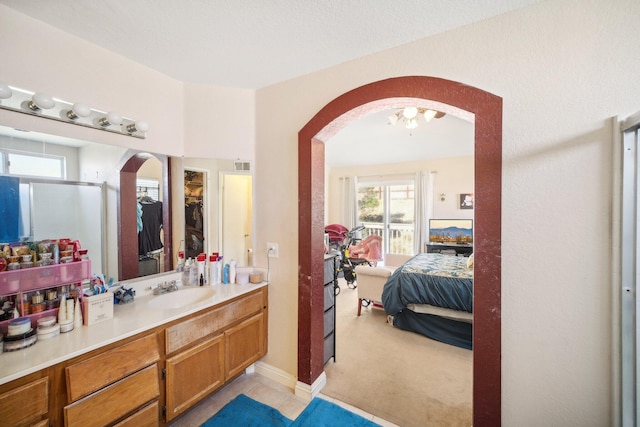 bathroom with tile patterned floors, vanity, and an inviting chandelier