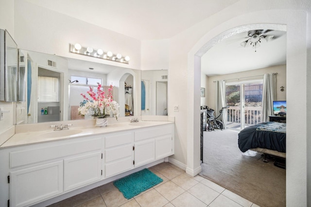 ensuite bathroom featuring ensuite bathroom, a sink, visible vents, tile patterned floors, and double vanity