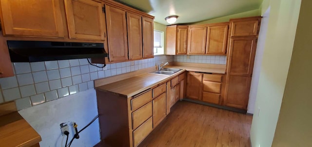 30650 233rd St, Llano, CA 93544 - kitchen featuring extractor fan, a sink, decorative backsplash, light wood-type flooring, and brown cabinets