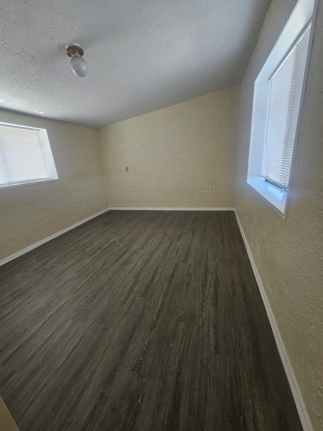 30650 233rd St, Llano, CA 93544 - empty room featuring a textured wall, baseboards, dark wood-style flooring, and a textured ceiling