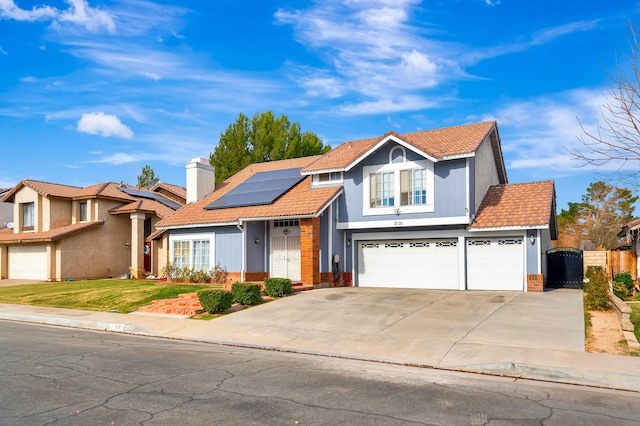 view of front of property with solar panels and a garage