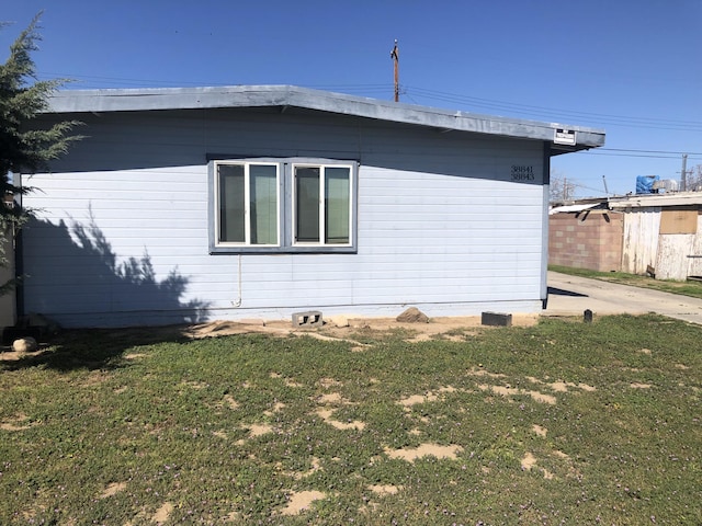 view of side of home featuring a lawn