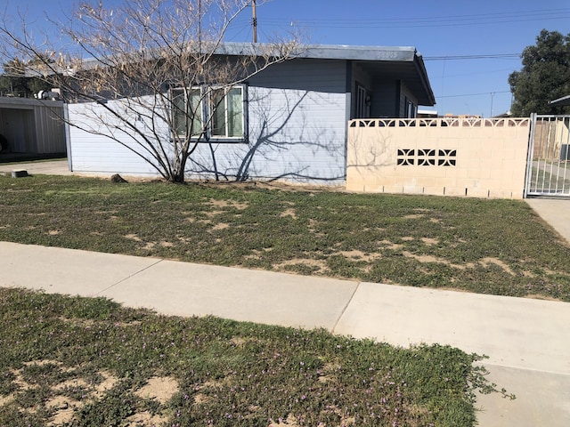 view of side of property with a lawn