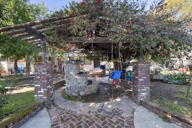 view of patio / terrace with a pergola and fence