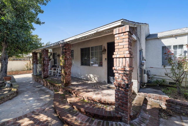 view of front of property featuring fence and stucco siding