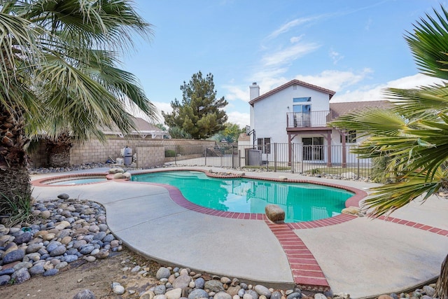 view of pool featuring a patio, an in ground hot tub, a fenced in pool, and a fenced backyard