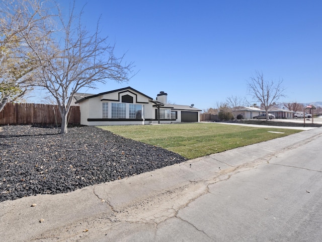 single story home featuring a front lawn and a garage