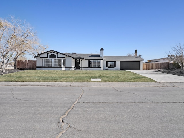 ranch-style home featuring a front yard and a garage