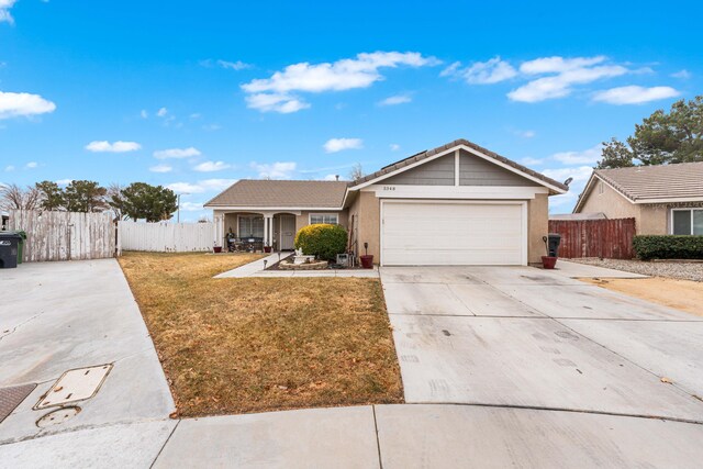 ranch-style home featuring a garage and a front yard