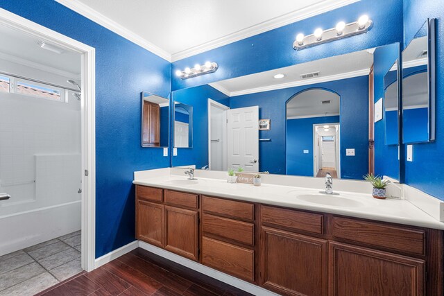 kitchen featuring white appliances, tile counters, sink, light tile patterned floors, and crown molding