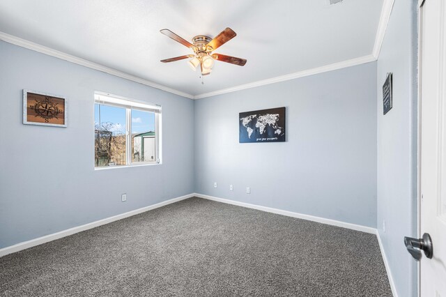 unfurnished bedroom with ceiling fan, ornamental molding, a closet, and dark carpet