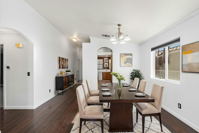 unfurnished room featuring crown molding, dark wood-type flooring, and ceiling fan with notable chandelier