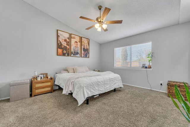 carpeted bedroom with ceiling fan, a textured ceiling, and vaulted ceiling