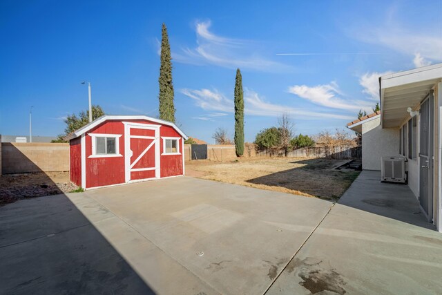 view of patio featuring cooling unit and a storage unit