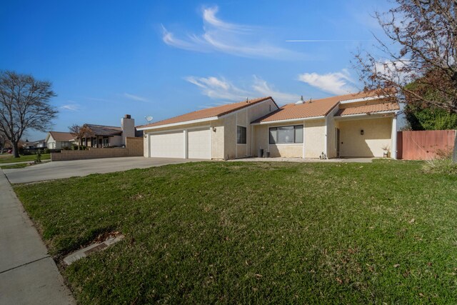 exterior space with a garage and a front lawn