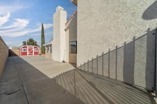 view of home's exterior featuring a patio area and a shed