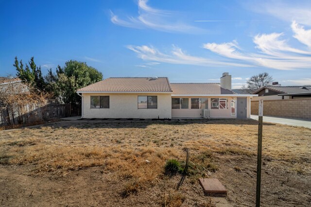 rear view of property featuring a yard