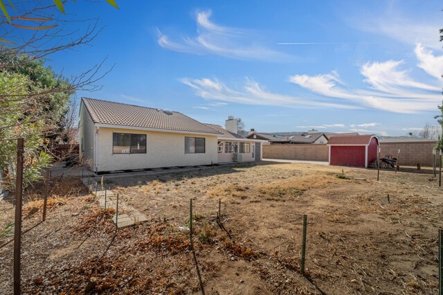 rear view of property with a shed