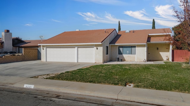 single story home featuring a front yard and a garage