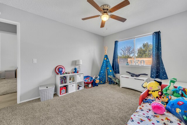 bedroom with carpet, a textured ceiling, and ceiling fan