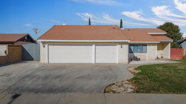 view of front of house featuring a front yard and a garage