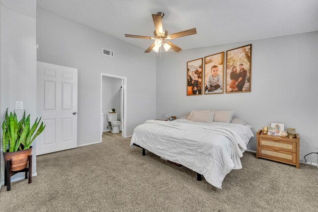 bedroom with carpet, ensuite bathroom, ceiling fan, and vaulted ceiling