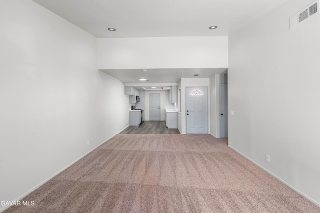 37632 E 15th St, Palmdale, CA 93550 - unfurnished living room with light colored carpet, washer / dryer, and recessed lighting