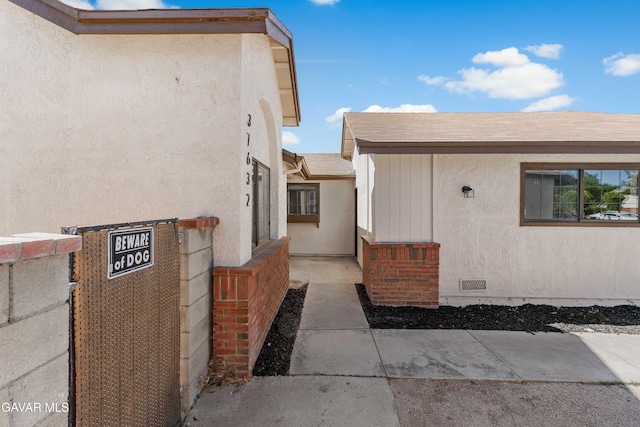 37632 E 15th St, Palmdale, CA 93550 - view of exterior entry featuring stucco siding and crawl space
