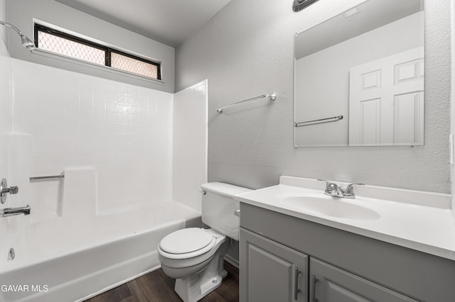 37632 E 15th St, Palmdale, CA 93550 - bathroom with vanity, wood finished floors, washtub / shower combination, and a textured wall