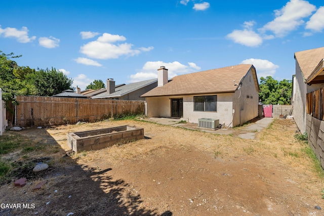 37632 E 15th St, Palmdale, CA 93550 - back of house featuring a vegetable garden, a fenced backyard, stucco siding, and a shingled roof