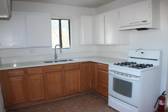 kitchen featuring range hood, white range with gas cooktop, and sink