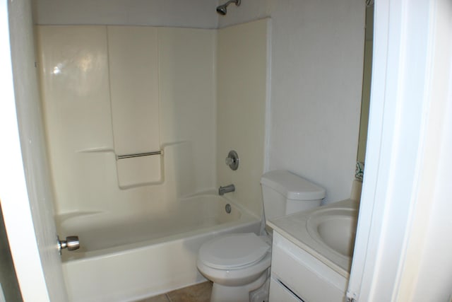 full bathroom featuring washtub / shower combination, tile patterned floors, vanity, and toilet