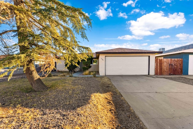 ranch-style house with a garage and a front yard