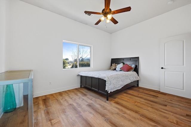 bedroom with hardwood / wood-style flooring and ceiling fan