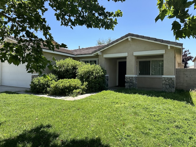 view of front of house featuring concrete driveway, stone siding, an attached garage, a front yard, and stucco siding