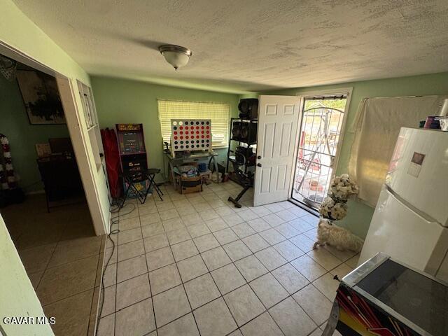 45529 Sancroft Ave, Lancaster, CA 93535 - foyer featuring light tile patterned floors and a textured ceiling