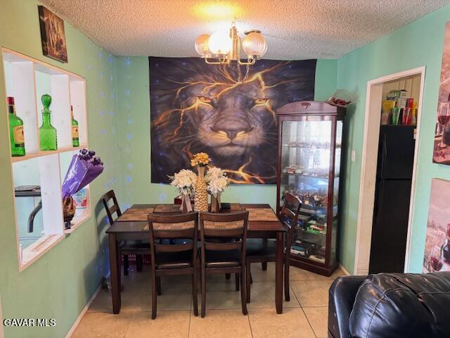 45529 Sancroft Ave, Lancaster, CA 93535 - tiled dining space featuring a chandelier and a textured ceiling