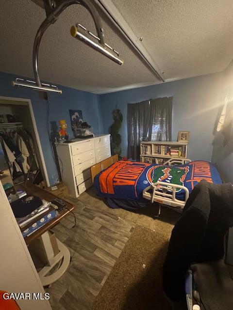 45529 Sancroft Ave, Lancaster, CA 93535 - bedroom with a textured ceiling and wood finished floors