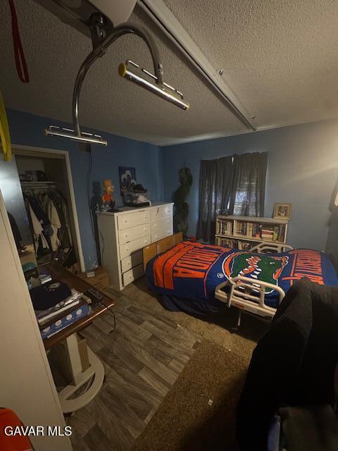 45529 Sancroft Ave, Lancaster, CA 93535 - bedroom featuring a textured ceiling and wood finished floors