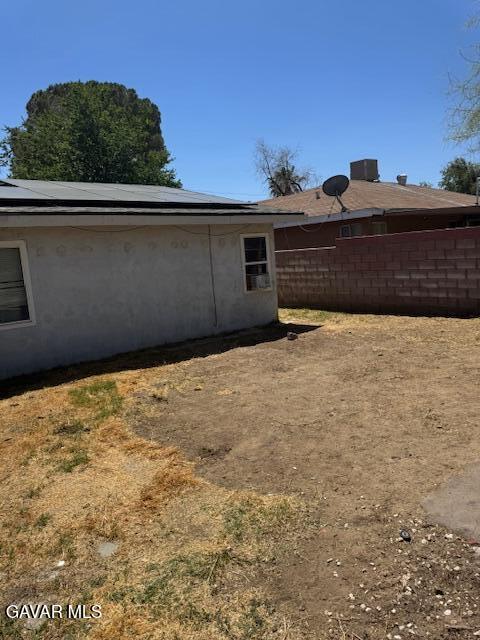 45529 Sancroft Ave, Lancaster, CA 93535 - view of side of home featuring solar panels and stucco siding