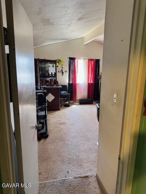 45529 Sancroft Ave, Lancaster, CA 93535 - hallway with vaulted ceiling, carpet flooring, and a textured ceiling