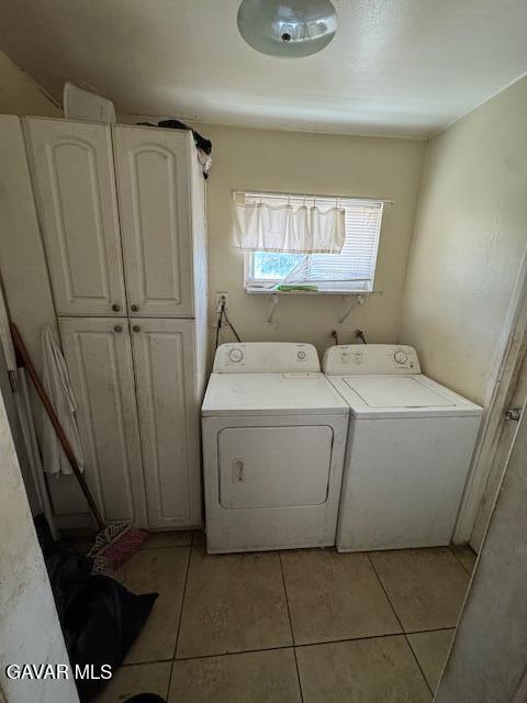 45529 Sancroft Ave, Lancaster, CA 93535 - washroom with cabinet space, separate washer and dryer, and light tile patterned floors